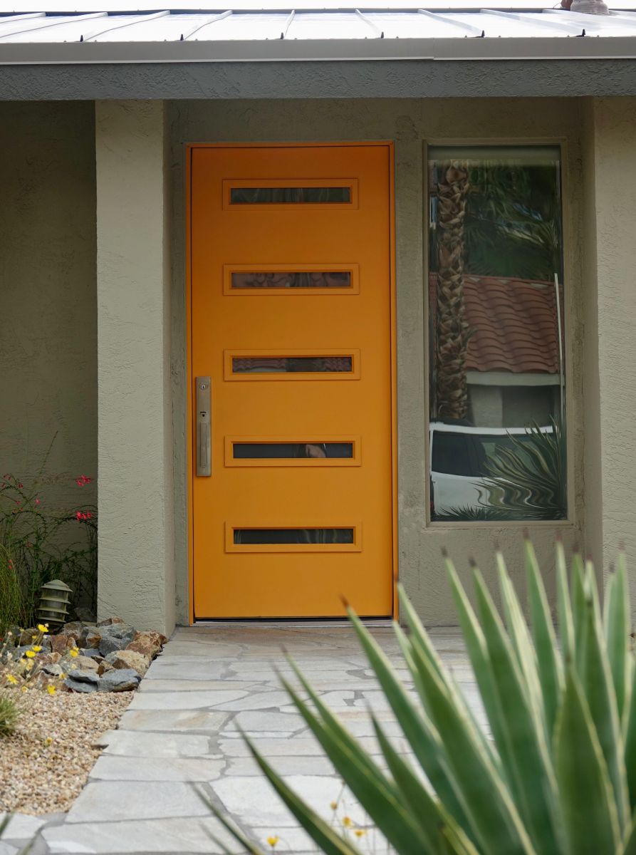 modern home with modern orange front door