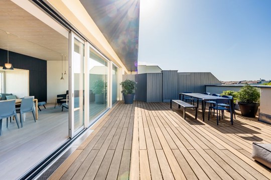 A deck with a table and chairs