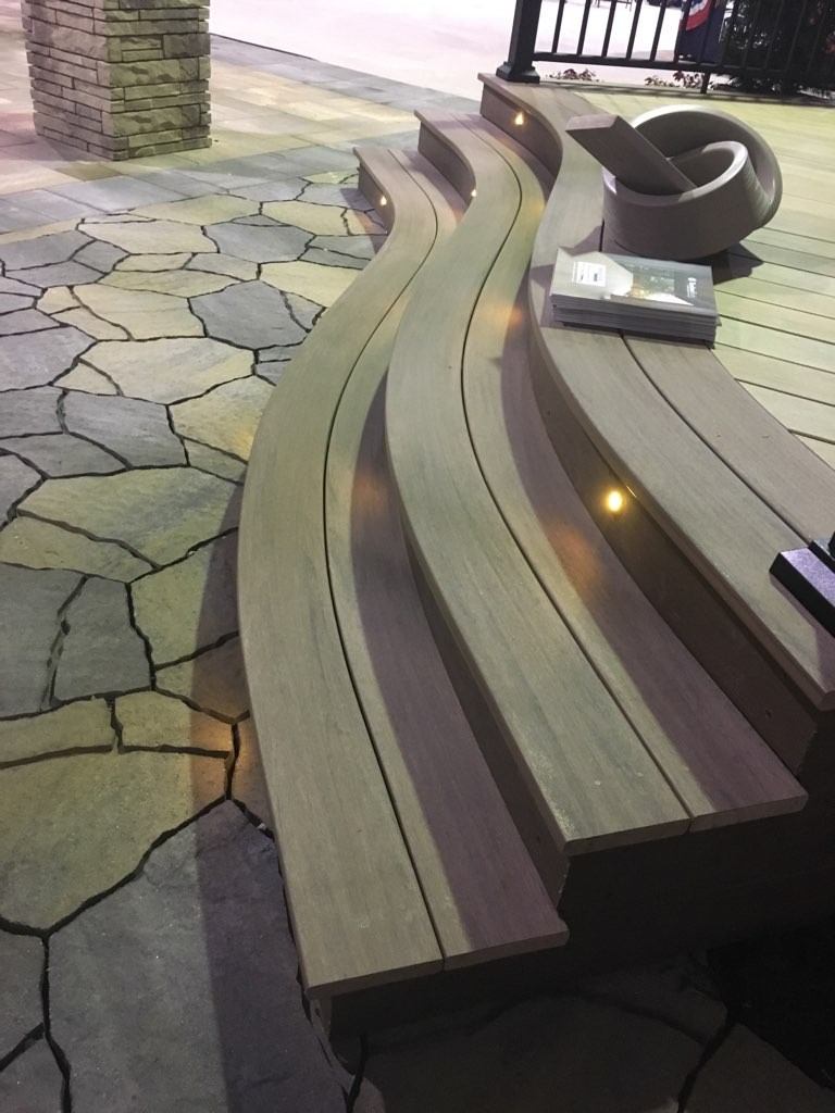 Curved TimberTech deck seating and stone patio at Majestics Outdoor Display in Raleigh, NC