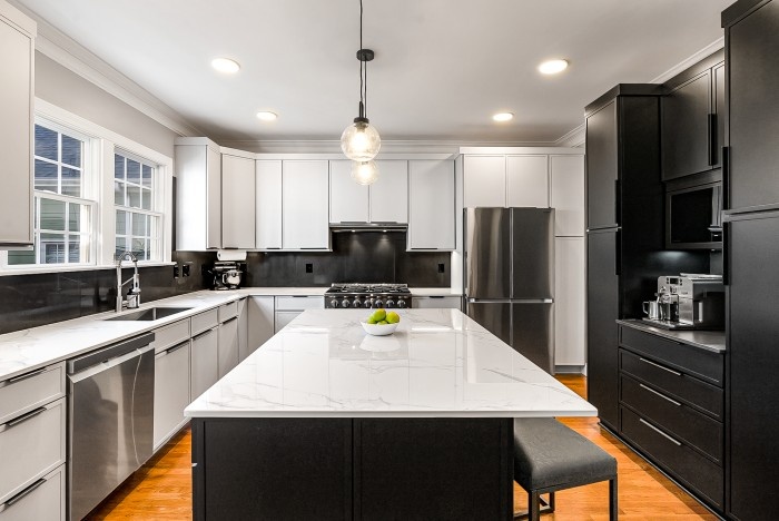 Contemporary kitchen with black cabinets, island seating, and pendant lighting