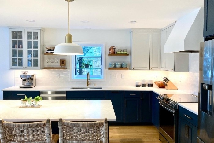 Modern black and white kitchen with large island and stainless steel appliances