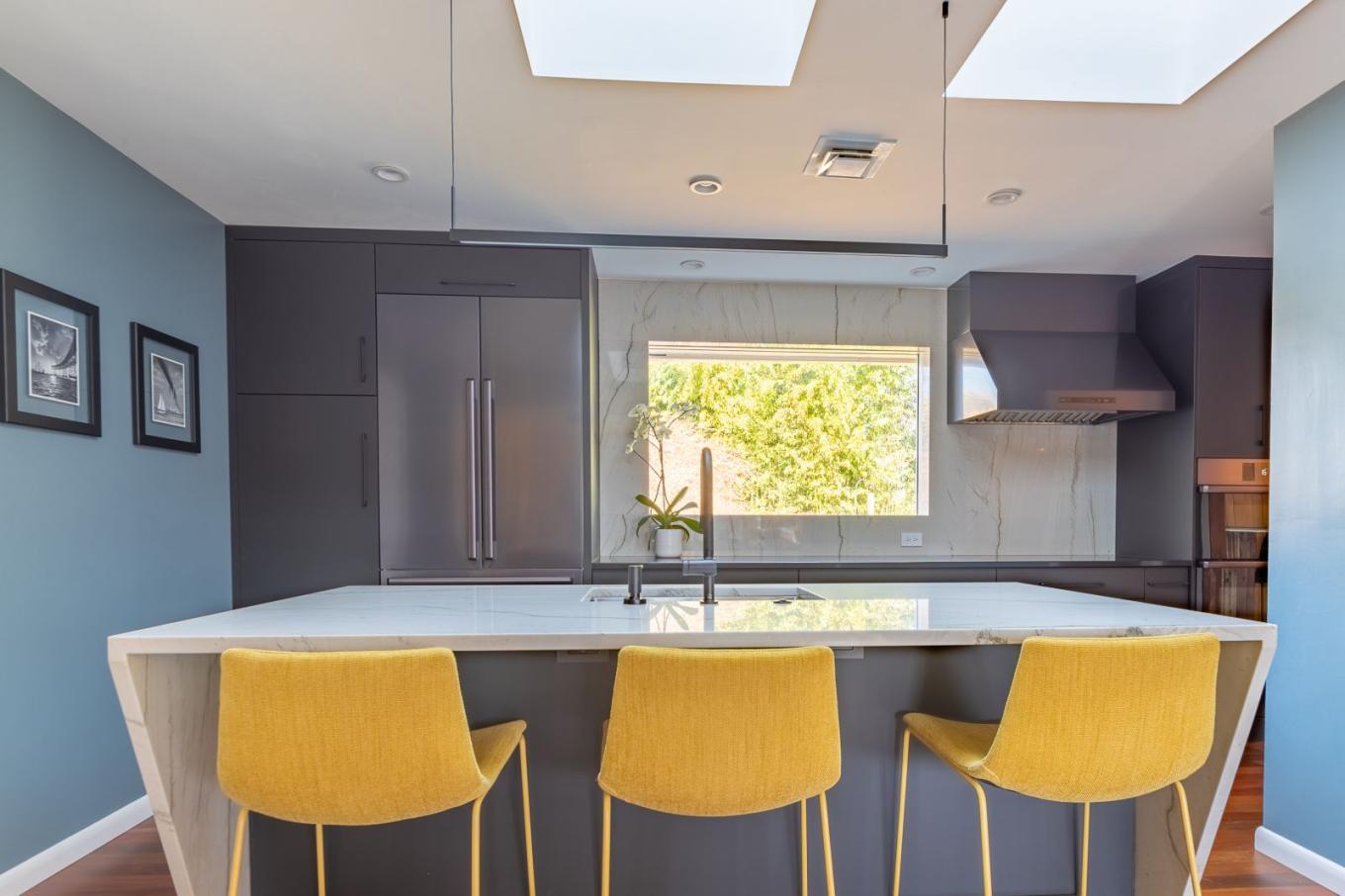 Kitchen remodel with blue walls and yellow chairs designed by American Cedar in Baltimore, MD