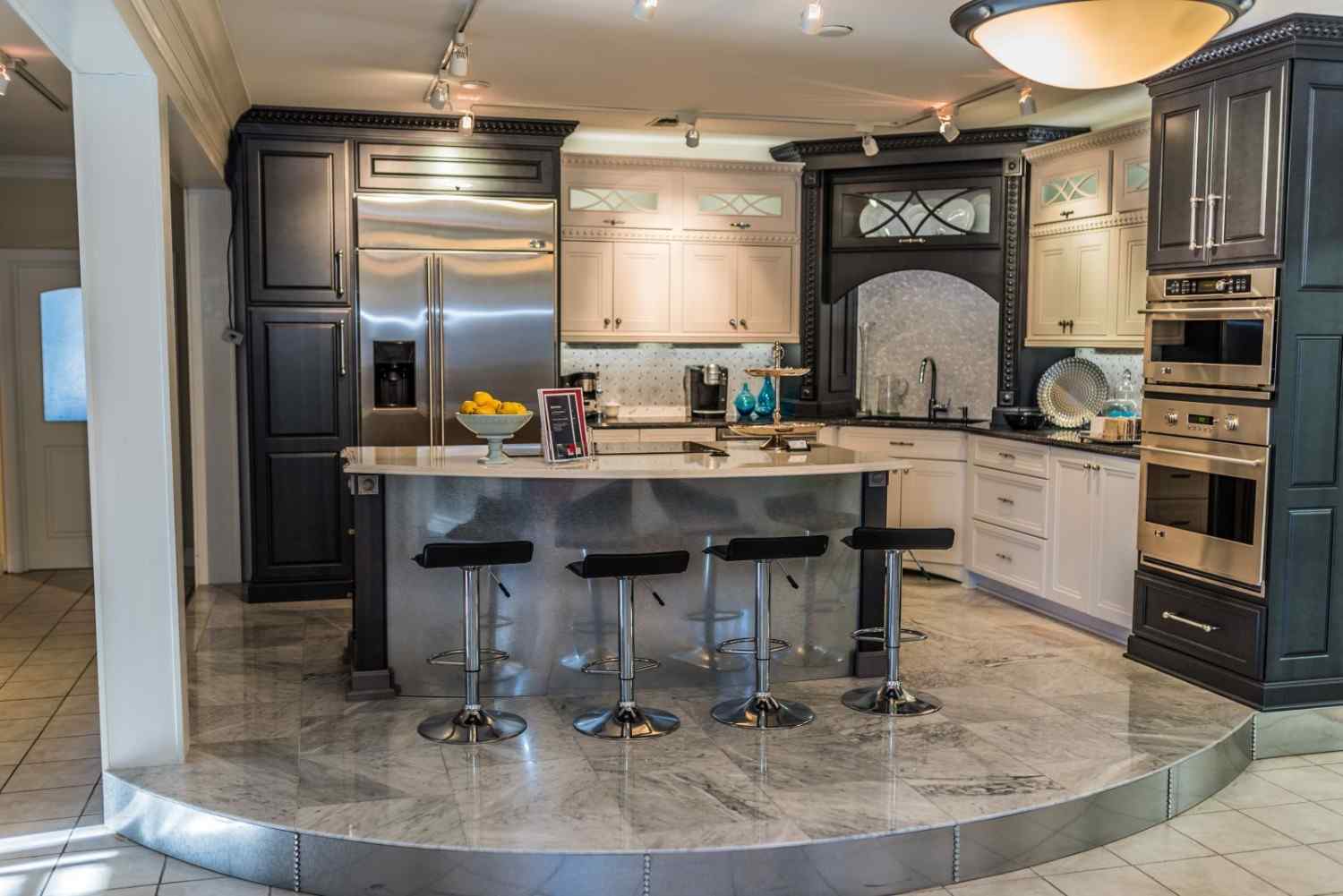 Kitchen showroom display with island seating and custom cabinetry