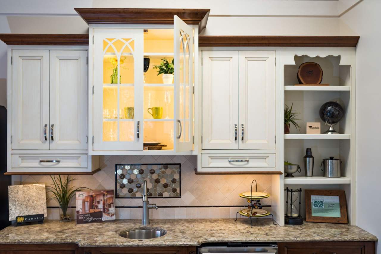 Kitchen showroom displaying a sink, cabinets, and contemporary lighting designs in Baltimore, MD