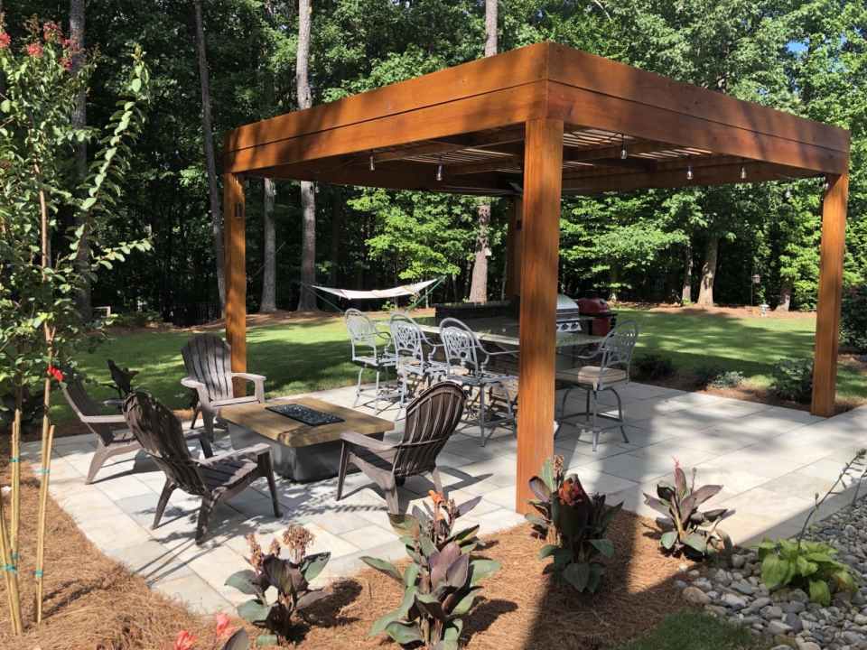 Modern wooden pergola with a dark stain finish, designed to enhance the outdoor living space
