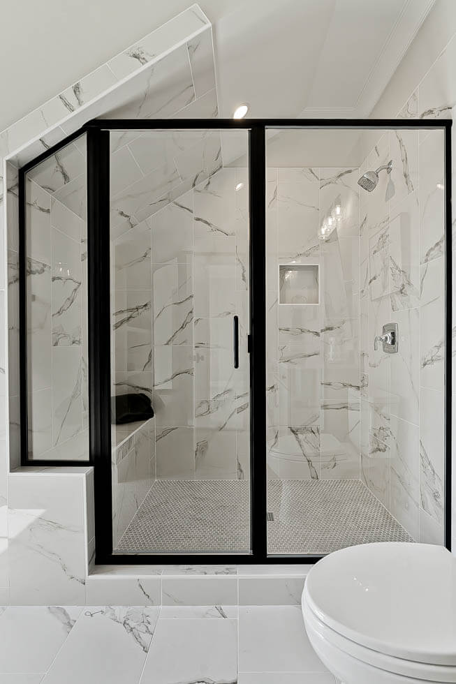 Modern bathroom featuring a marble floor and glass shower door in Millersville and Baltimore, MD