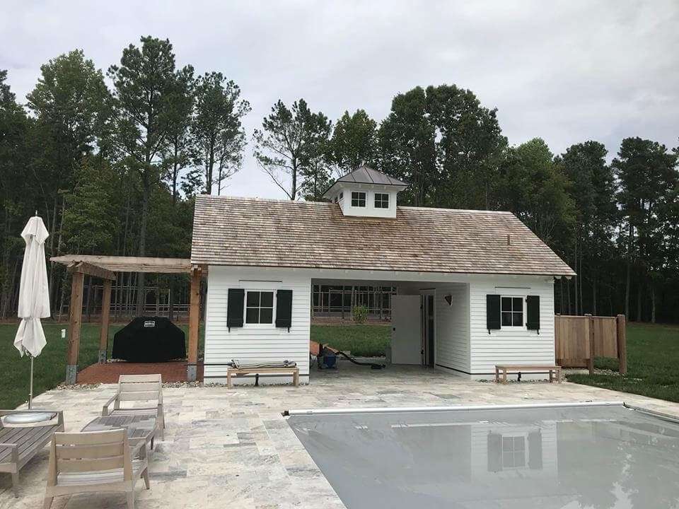 Poolhouse project by Habalis Construction featuring custom windows, shutters and outdoor living space