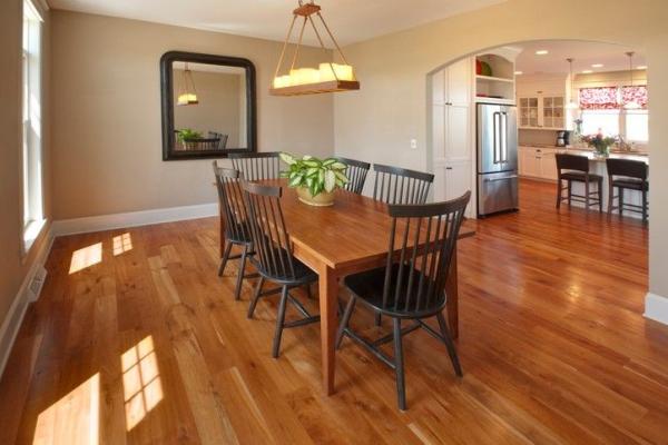 Dining room with hardwood flooring and custom woodwork by American Cedar & Millwork