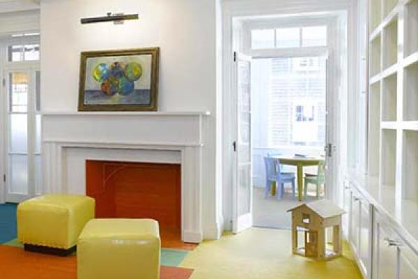 White interior moulding with ceiling beams and decorative fireplace