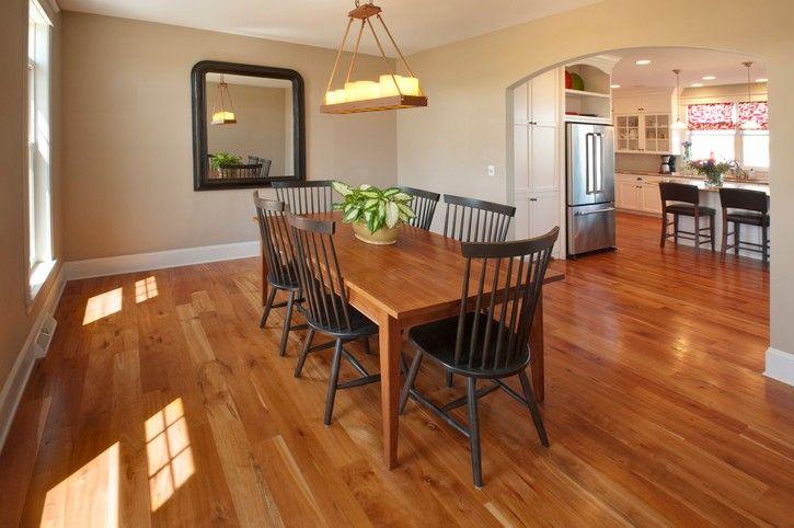 Dining room with hardwood flooring and custom woodwork by American Cedar & Millwork