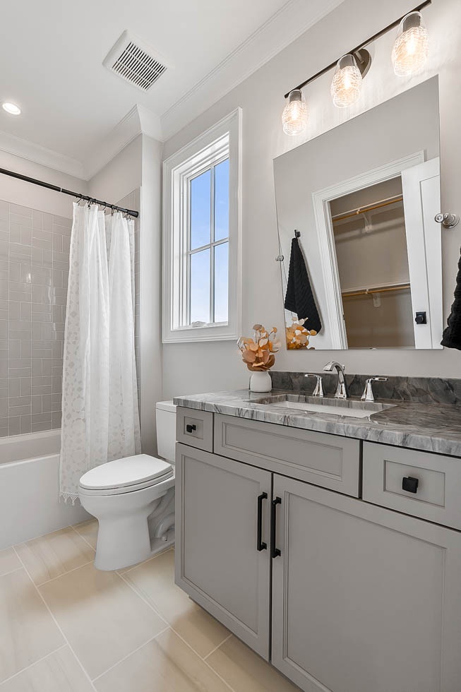 A bathroom featuring a sink, toilet and shower, part of projects in Millersville and Baltimore, MD