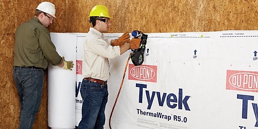 Two men installing Tyvek sheet, showcasing protection benefits in Millersville & Baltimore, MD
