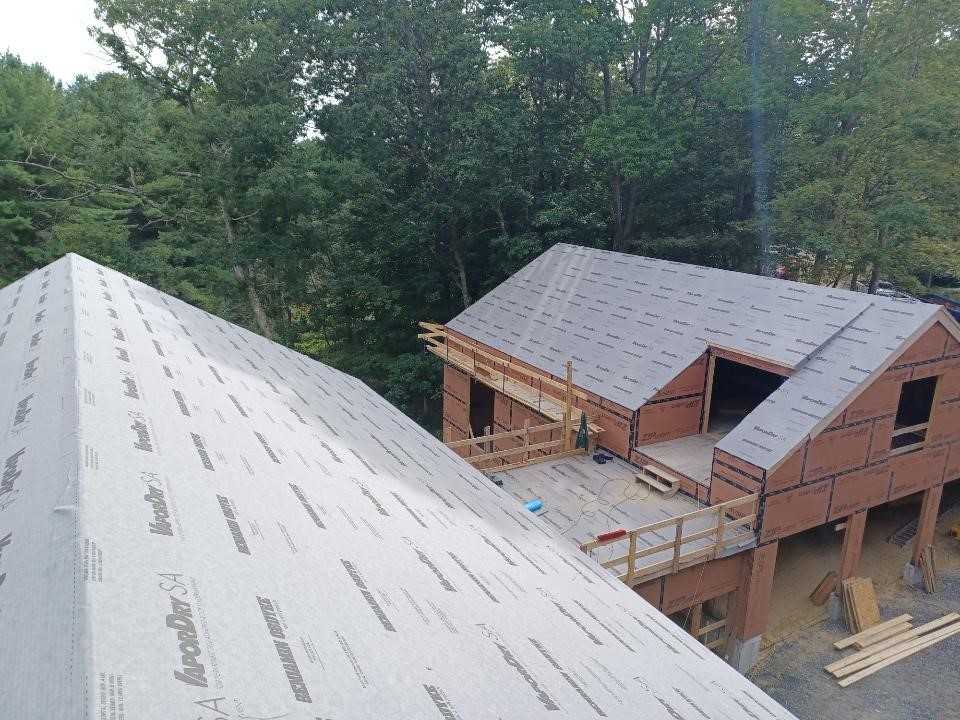 A House under construction with a partially built roof and scaffolding in Raleigh, NC
