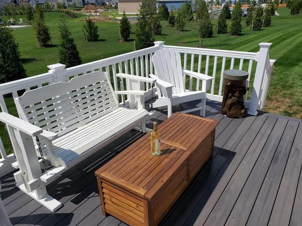 Deck featuring a wooden bench and white chair in Millersville and Baltimore, MD