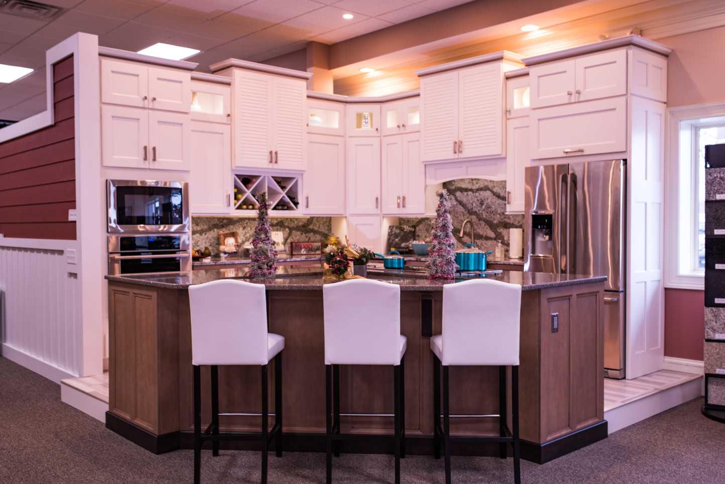 A sleek white cabinet filled with wine bottles in the modern kitchen located in Baltimore, MD